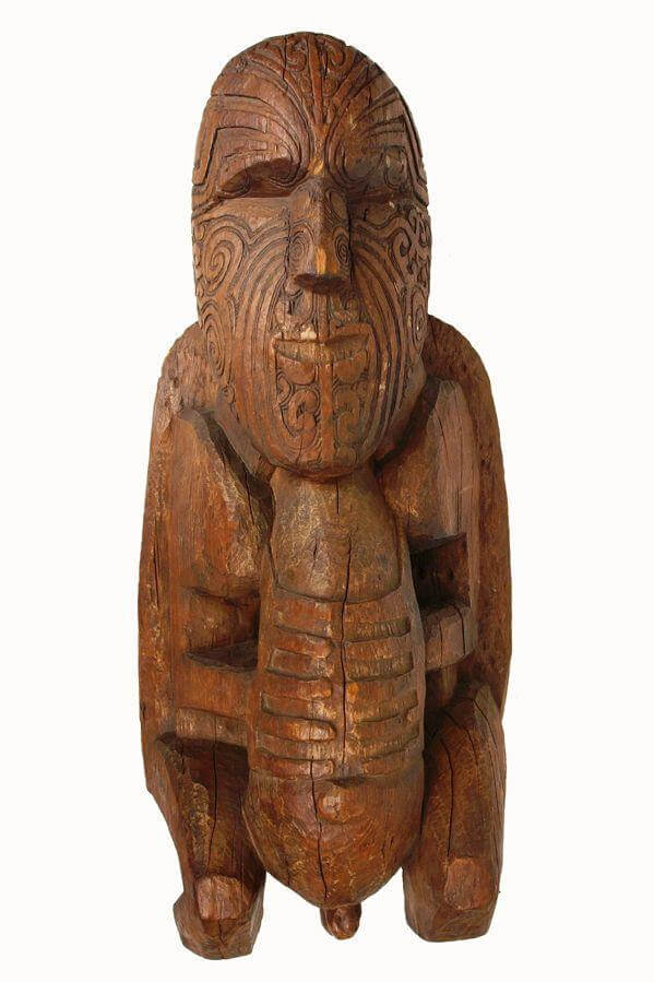 Carved wooden figure with facial tattoos